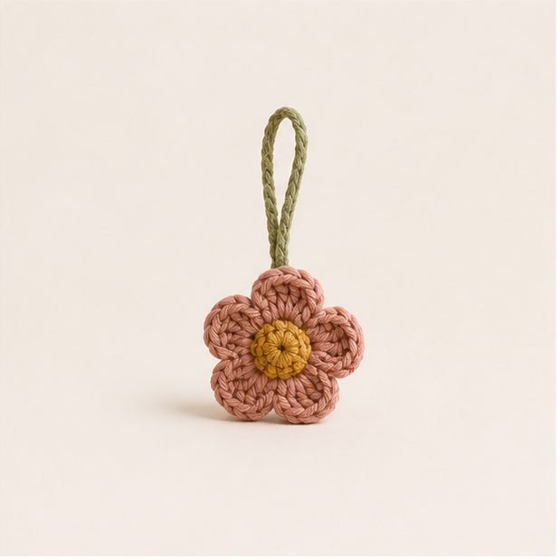 Small rose crochet flower charm with a gold centre and sage loop